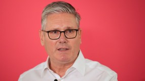Prime Minister Keir Starmer speaks at a press conference addressing future leadership rumours, wearing a navy suit and tie.