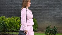 Keanu Reeves wearing a pink outfit at a public event, capturing attention with his unique fashion choice and charismatic p...