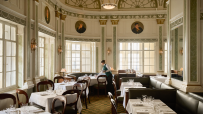 Romanos restaurant inside Simpsons in the Strand, featuring elegant decor and a vibrant dining atmosphere