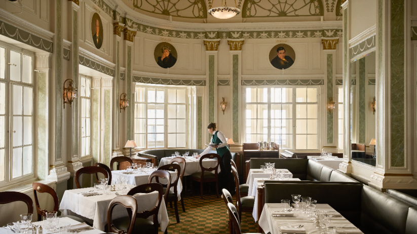 Romanos restaurant inside Simpsons in the Strand, featuring elegant decor and a vibrant dining atmosphere