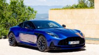 Aston Martin BD12 luxury sports car showcasing sleek design and high-performance features on a scenic road