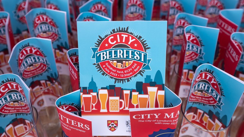 City Beerfest attendees enjoying a sunny day in London with iconic skyline views, organized by City of London Corporation.