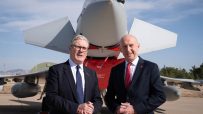 Healey and Starmer engage in discussion at a public event, focusing on key policy issues and future strategies.