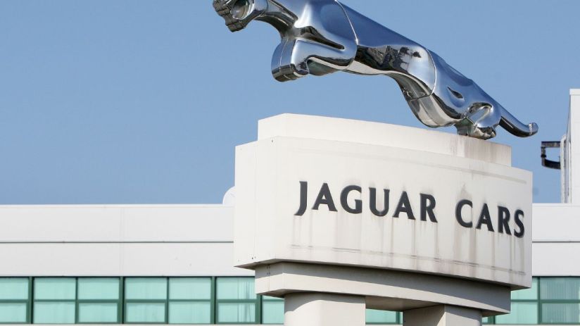 JLR logo prominently displayed on a modern office building, representing innovation and leadership in the automotive industry