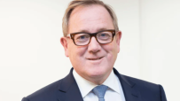 Mark Dixon, CEO of IWG, in a business setting discussing flexible workspace solutions and future industry trends.