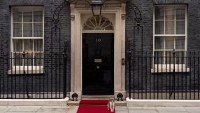 Number 10 Downing Street entrance with iconic black door and brass letterbox, symbolizing UK Prime Ministers official resi...