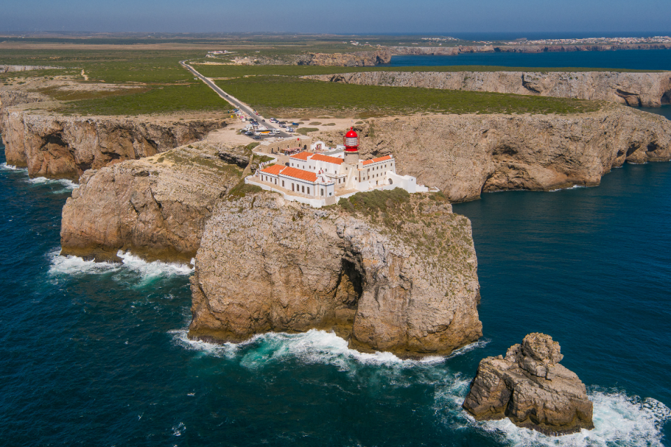 Scenic view of Algarve coastline in Portugal, featuring golden beaches, rugged cliffs, and clear blue waters under sunny s...