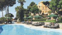 Scenic view of Sicilian coastline with historic architecture and vibrant Mediterranean landscape in Italy