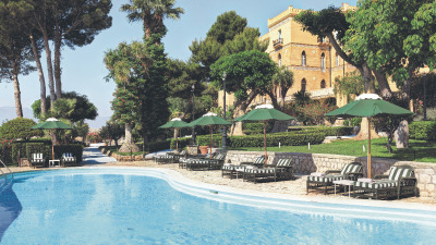 Scenic view of Sicilian coastline with historic architecture and vibrant Mediterranean landscape in Italy