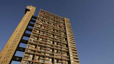 Trellick Tower UK council estate architecture, highlighting its iconic brutalist design against a clear sky backdrop.