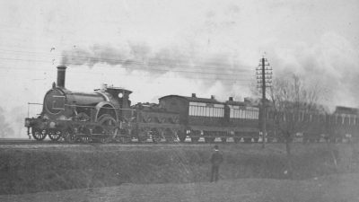 Victorian Express train journey showcasing historic locomotive and passengers in period attire for a scenic countryside ride