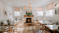 Exterior view of The Suffolk Restaurant showcasing its welcoming entrance and elegant signage in a bustling neighborhood s...