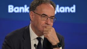 Andrew Bailey, Governor of the Bank of England, in a suit and tie, looking thoughtful during a press conference.