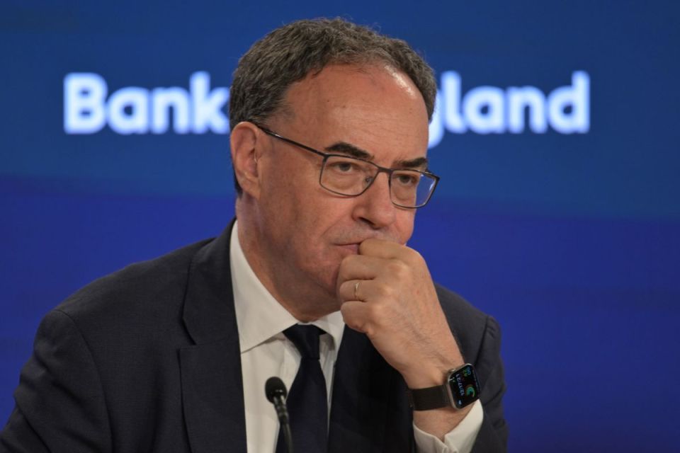 Andrew Bailey, Governor of the Bank of England, in a suit and tie, looking thoughtful during a press conference.