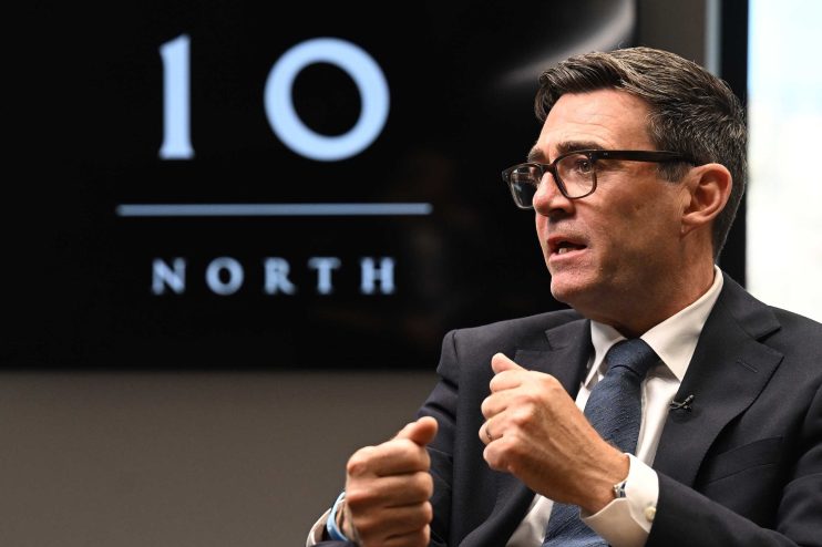 Andy Burnham speaking at 10 NORTH event, gesturing while discussing devolution plan.