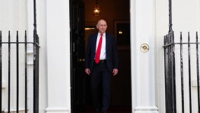 Chancellor John Healey speaking at a professional event, likely a press conference or address.