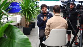Alex Albon of Williams Racing giving an interview, with a camera crew nearby and Atlassian branding visible.