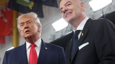Donald Trump and FIFA President Gianni Infantino smiling, looking upwards during an event.