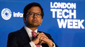 Kanishka Narayan, wearing glasses and a suit, speaks at London Tech Week, with the event logo visible.