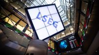 LSEG logo on a large digital screen with stock market tickers and financial data displays in a modern building