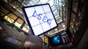 LSEG logo on a large screen inside a modern building with stock tickers and glass ceilings.