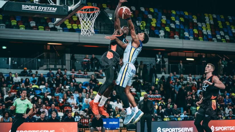 London Lions basketball team in action during a game, showcasing dynamic play and teamwork on the court.