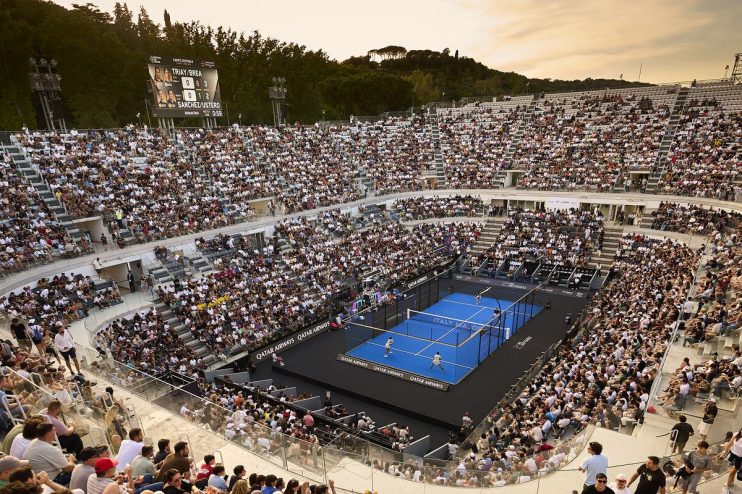 Padel match in a large, crowded stadium in Rome, Italy, with a scoreboard displaying scores.