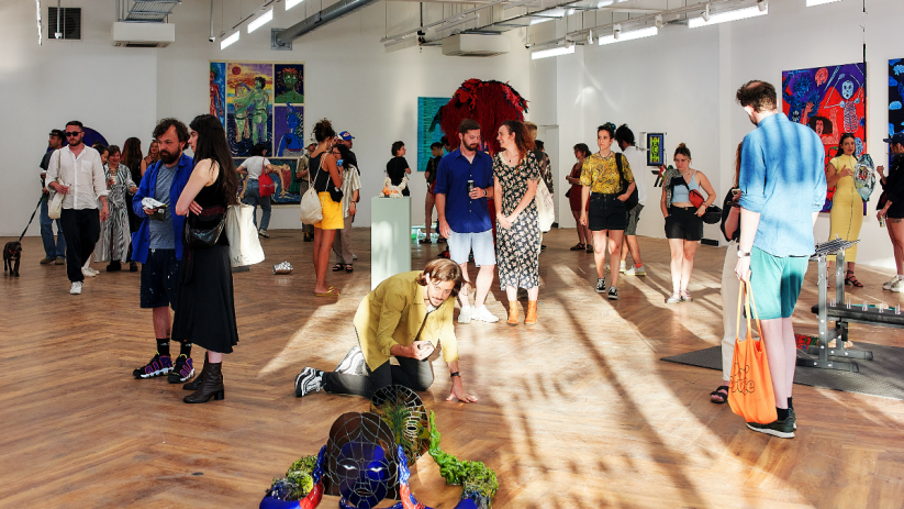 Visitors at the Square Mile art gallery viewing diverse contemporary artworks and sculptures.
