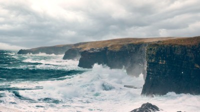 Scenic view of the Cliffs of Caithness, highlighting the rugged coastline near Old Pulteney distillery in Scotland.
