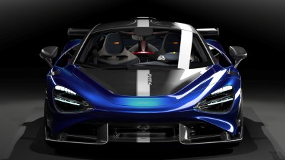McLaren supercar on display, showcasing sleek design and advanced engineering against a backdrop of a bustling automotive ...