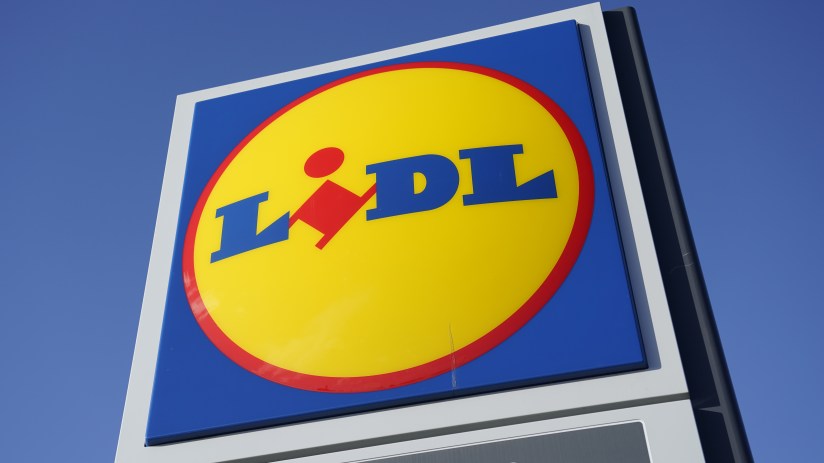 Lidl supermarket sign with blue, yellow, and red logo against a clear blue sky
