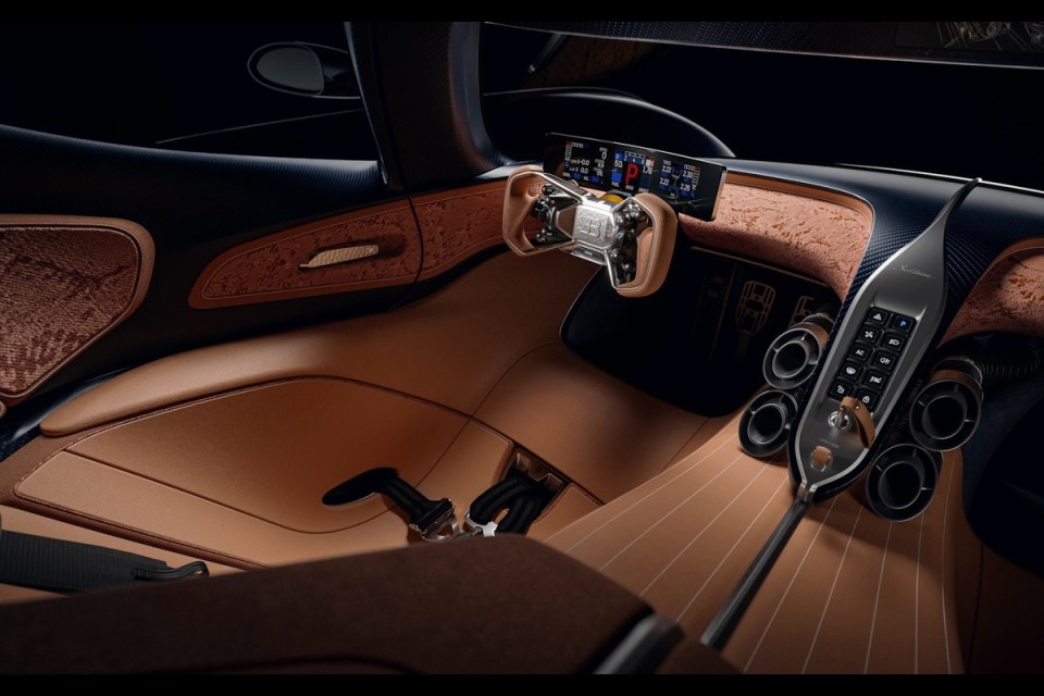 Luxurious interior of the Bugatti Solitaire Destrier with tan leather, detailed steering wheel, and control panel