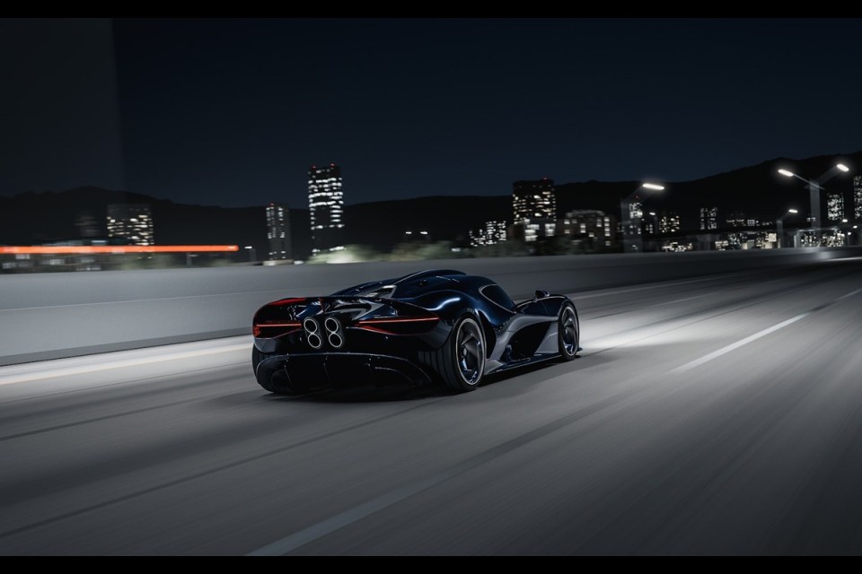 Dark blue Bugatti Solitaire Destrier hypercar driving at night on a highway with city lights in the background