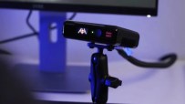 Seeing Machines Guardian device mounted on a desk, with a computer monitor in the background.