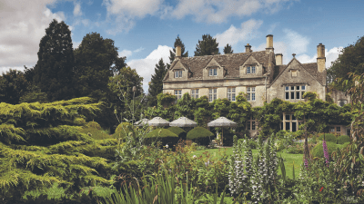 Elegant UK country house with lush gardens, perfect for a summer staycation or holiday retreat.