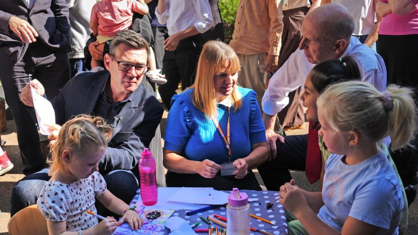 Andy Burnham and Angela Rayner interacting with children at an outdoor event