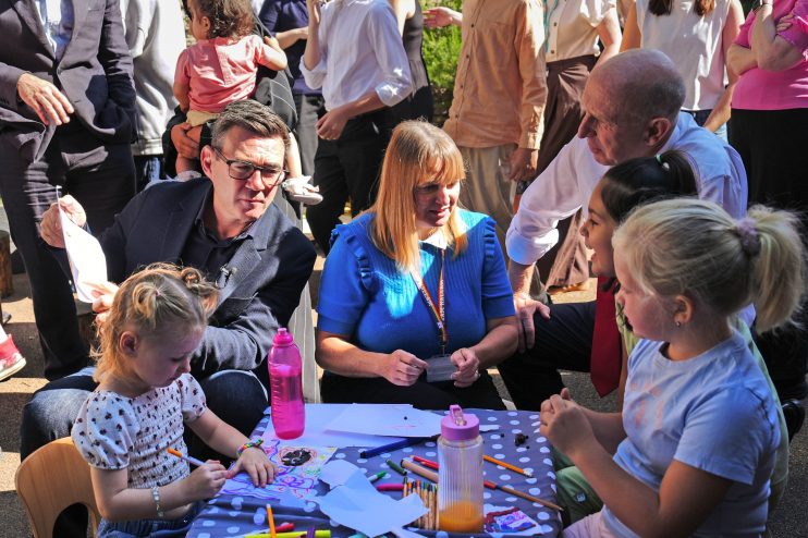 Andy Burnham and Angela Rayner interacting with children at an outdoor event