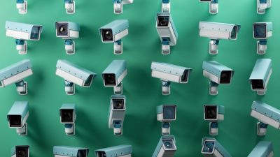 Multiple CCTV security cameras in light blue and white against a green background, emphasizing surveillance and monitoring.