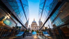 St Pauls Cathedral in London, framed by modern glass buildings under a clear sky, near Cavendishs base