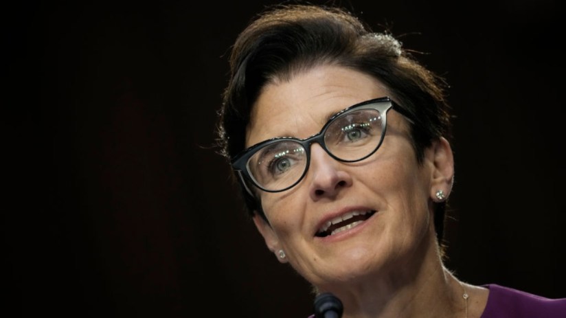 Jane Fraser, Citi CEO, speaking at a podium with a microphone, wearing glasses and a purple top.