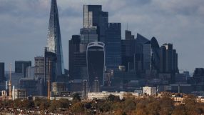 London skyline with The Shard, Walkie Talkie, and Gherkin skyscrapers towering over residential buildings and autumn trees.