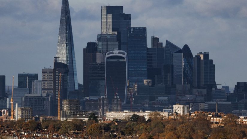 London skyline with The Shard, Walkie Talkie, and Gherkin skyscrapers towering over residential buildings and autumn trees.