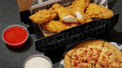 Dominos Chick N Dip box with crispy chicken strips, red hot sauce, ranch dip, and a cheesy pizza.