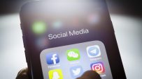 Smartphone screen displaying Social Media folder with Facebook, WeChat, Telegram, Twitter, Instagram, and Snapchat app icons.