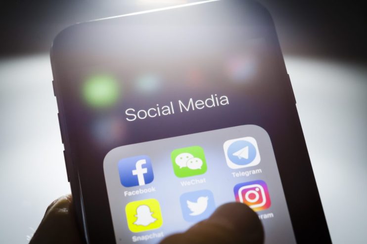 Smartphone screen displaying Social Media folder with Facebook, WeChat, Telegram, Twitter, Instagram, and Snapchat app icons.