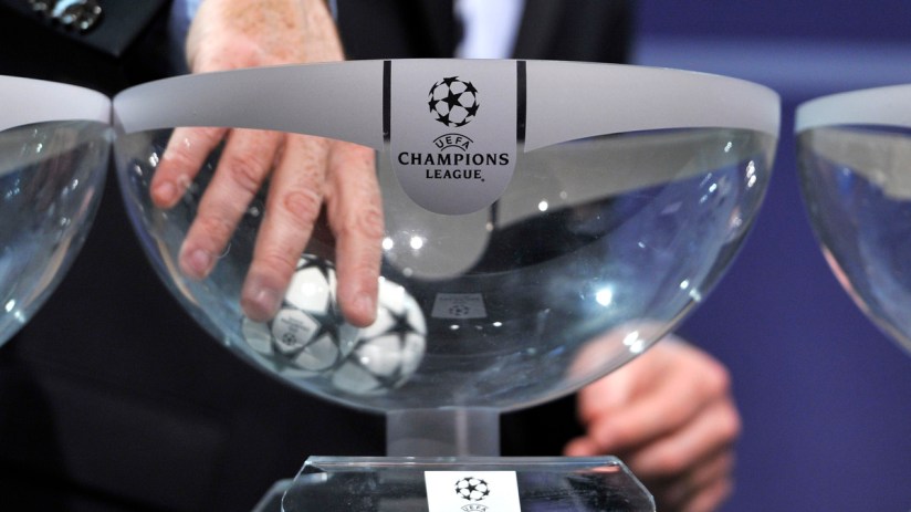 Hand drawing a UEFA Champions League football from a clear bowl during a draw ceremony