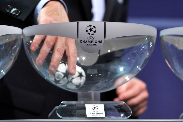 Hand drawing a UEFA Champions League football from a clear bowl during a draw ceremony
