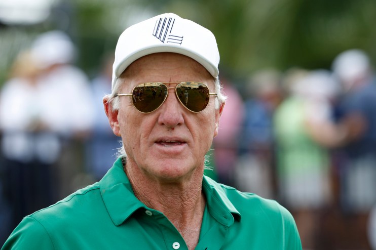 Greg Norman, CEO of LIV Golf, wearing a white cap, sunglasses, and a green polo shirt outdoors.