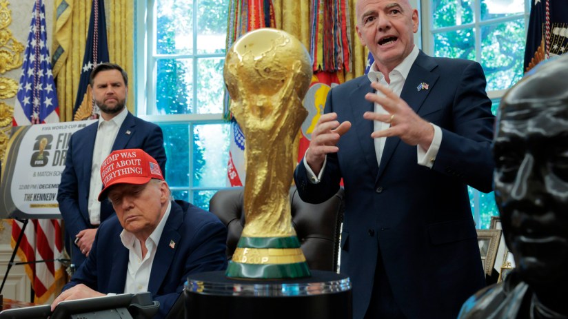 Gianni Infantino speaks near the FIFA World Cup trophy as Donald Trump sits, wearing a red Trump Was Right About Everythin...