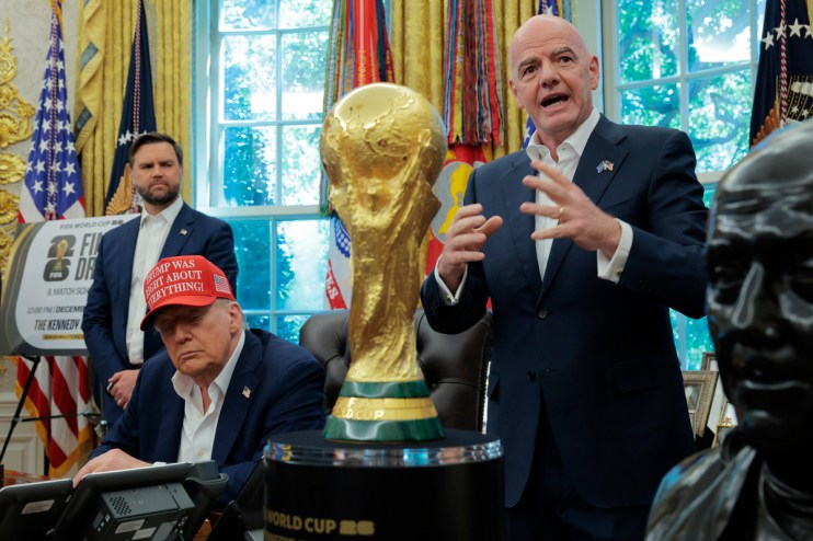 Gianni Infantino speaks near the FIFA World Cup trophy as Donald Trump sits, wearing a red Trump Was Right About Everythin...